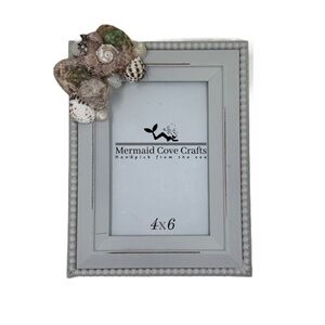 Gray 4x6 picture frame with seashells in the corner, ideal for coastal decor.